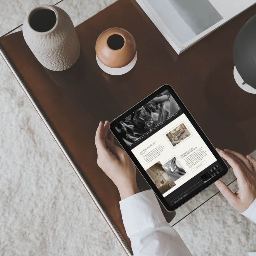 iPad on coffee table, held by a womans hand. Display shows screenshot of website homepage.